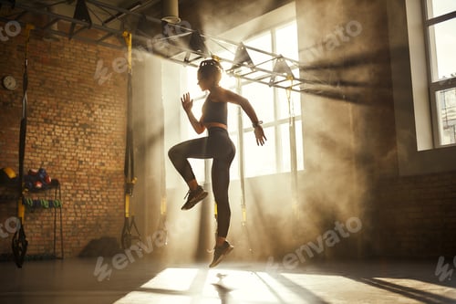 Preview: Always in good shape Full length of athletic woman in black sport clothing exercising in