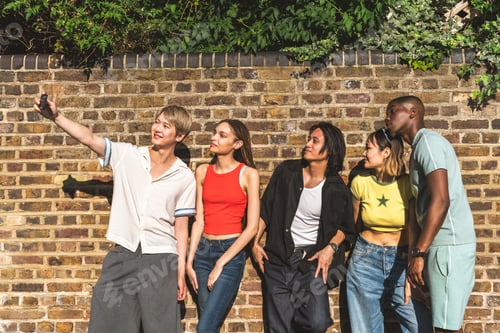 Preview: Multiracial group of happy young friends bonding in London