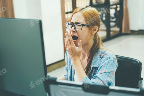 Preview: Young woman covering her face with both hands with the stress of work.