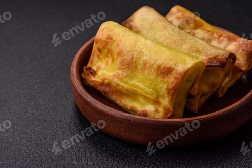 Preview: Homemade fried pancakes with filling on a ceramic plate