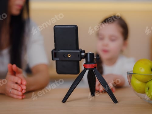 Preview: Blogger mom with her baby at home. Millennial Influencer woman creating content for her motherhood