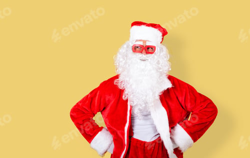 Preview: smiling and relaxed Santa Claus with modern red glasses looking to the copy space