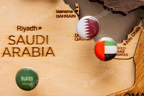 Preview: Saudi Arabia, United Arab Emirates, Qatar flags on the push pins on the wooden map, close up