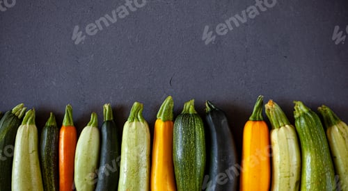 Preview: Fresh zucchini of different colors green, yellow, orange, white. Harvest vegetables on a dark top