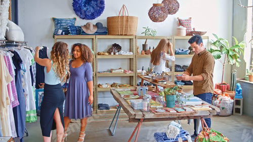 Preview: Interior Of Fashion Store With Customers Being Helped By Staff