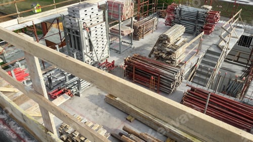 Preview: View of construction site with lots of stacked poles, pillars, and other materials