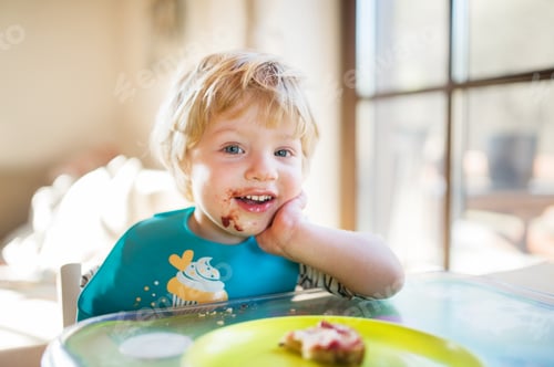 Preview: A toddler boy eating at home.