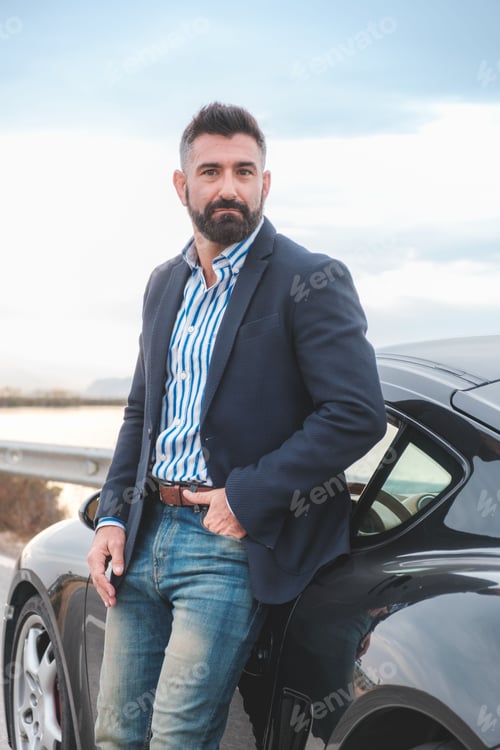 Preview: Handsome elegant male leaning on his sports car