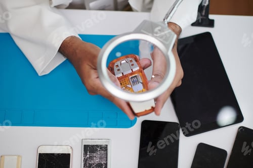 Preview: Technician Examining Feature Phone