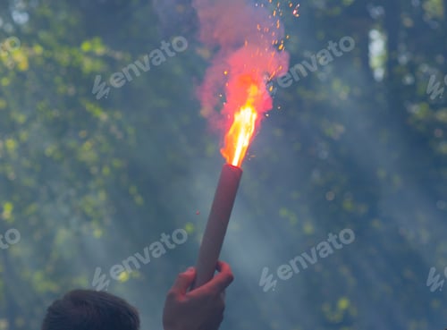Preview: A football fan is holding a burning firecracker
