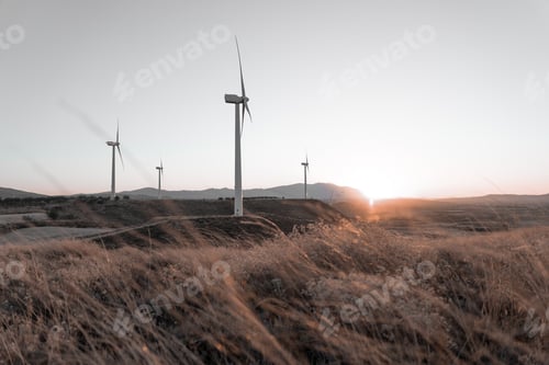 Preview: Beautiful watch of a wind farm during sunset. Concept of protecting the environment.