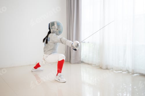 Preview: Before the tournament day, a girl dressed in fencing gear are rehearsing in gym
