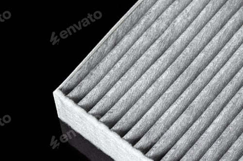 Preview: Car engine filter on dark background, close up.
