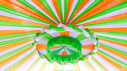 Preview: Decorative hanging tent roof of outdoor event with colorful fabric decoration, low angle view