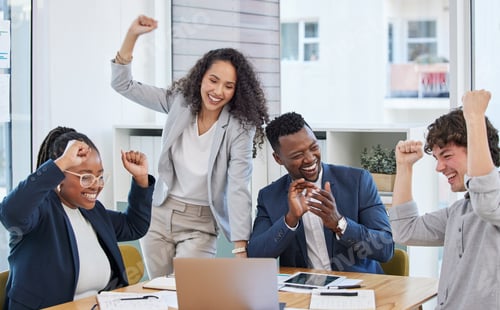 Preview: Succeeding in their mission as a team. Shot of a group of businesspeople cheering in an office.