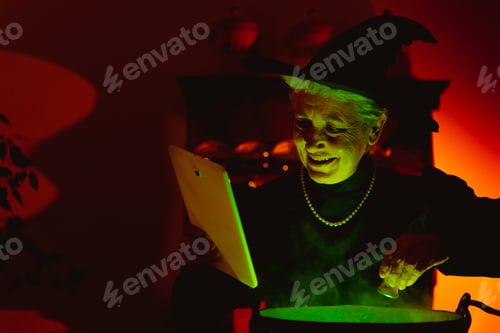 Preview: old witch performing witchcraft using modern technology