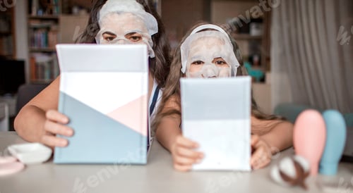 Preview: Girl and her mom watching beauty master class with tablets online and doing spa procedure at home