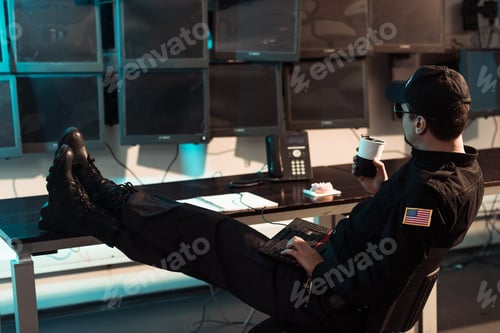 Preview: prison guard sitting with legs on table and monitoring people in jail