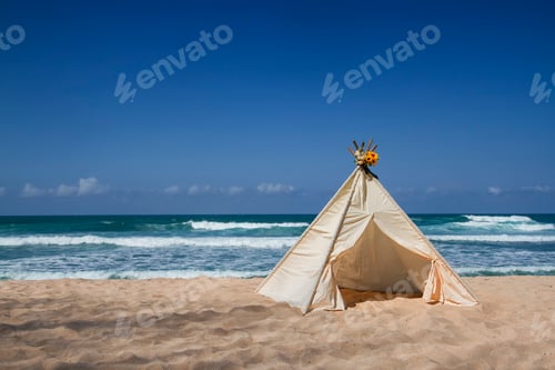 Preview: teepee tent with flower on top on the beach