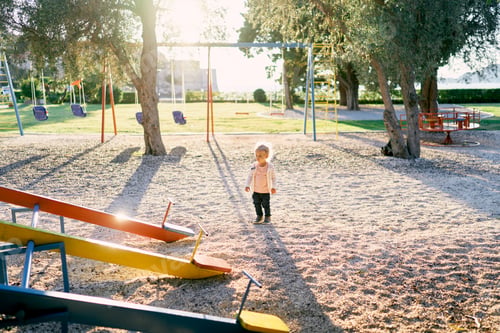 Preview: Little girl walks along the playground to the swing-balancer