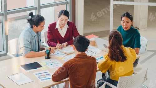 Preview: Multiracial group of young people discussing business brainstorming meeting in modern office.