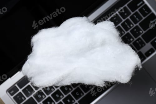 Preview: A white cloud made of cotton wool on a laptop keyboard