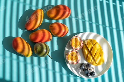 Preview: fruit slices on the plate: mango, passion fruit and grapes