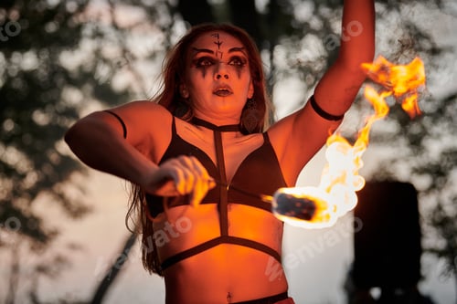 Preview: Girl fire dancing performance at outdoor art festival, smooth movements of female artist
