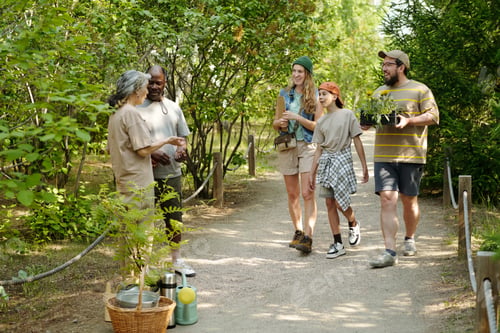 Preview: Multiethnic Group of Adults and Teenager Walking Outdoors Carrying Plants