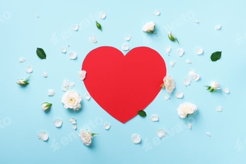 Preview: Red paper heart, white roses and petals on blue pastel background. Spring or summer concept
