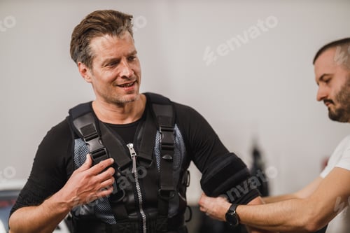Preview: Fitness Instructor Putting An Ems Suit To A Man