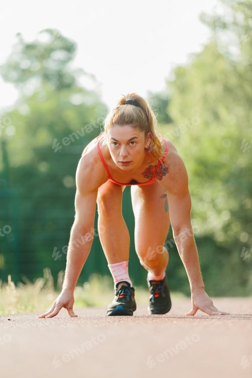 Preview: Determined woman starting race on outdoor track