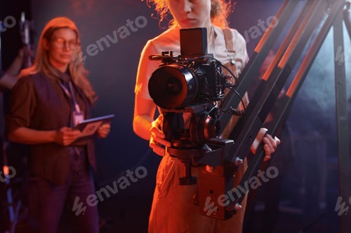 Preview: Woman Operating Video Camera in Neon Lights
