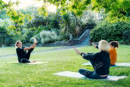 Preview: Female yoga class in park. Group of diverse women doing stretching pose exercising together