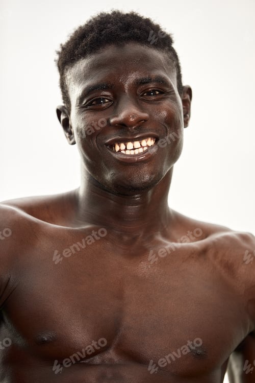 Preview: African man smiling after workout. He is in a park.