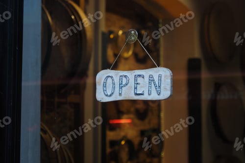 Preview: Open sign hangs in the window of a small shop