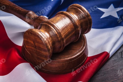 Preview: Wooden gavel and USA flag on table close up
