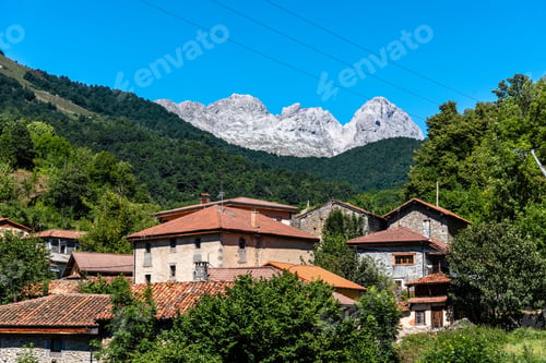 Preview: A scenic view of Oseja de Sajambre, Spain, with traditional stone buildings