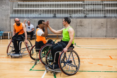 Preview: Wheelchair basketball players high fiving during a game