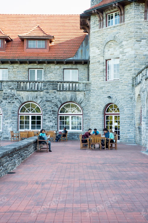 Preview: Students sitting on patio outside university building