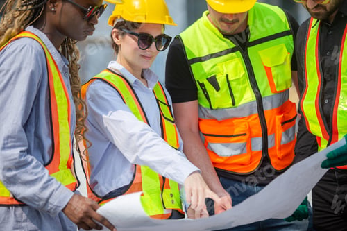 Preview: Engineering and foreman looking check at plan on blueprint in construction site working project.