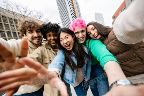 Preview: Multiracial group of young friends smiling while taking selfie