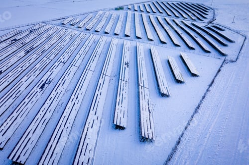 Preview: Snowy photovoltaic farm in winter. Aerial view of alternative energy