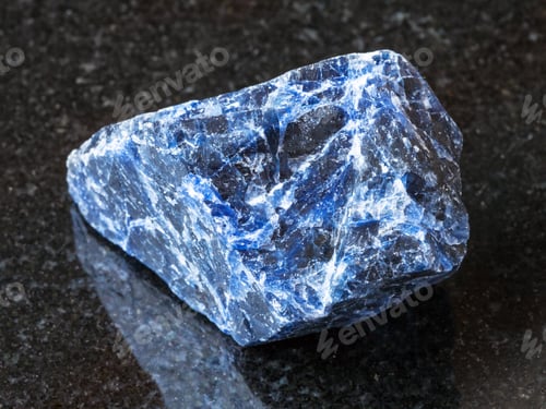 Preview: raw Sodalite gemstone on black granite