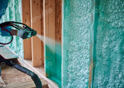 Preview: Worker spraying polyurethane foam for insulating wooden frame house.