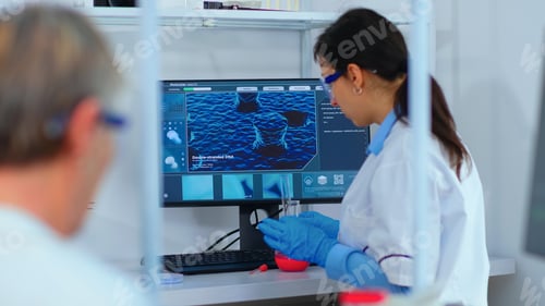 Preview: Woman research chemist testing virus sample