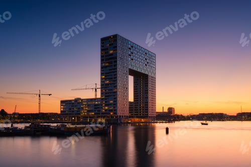 Preview: Amsterdam, Netherlands. A cityscape in the evening. A skyscraper and business center