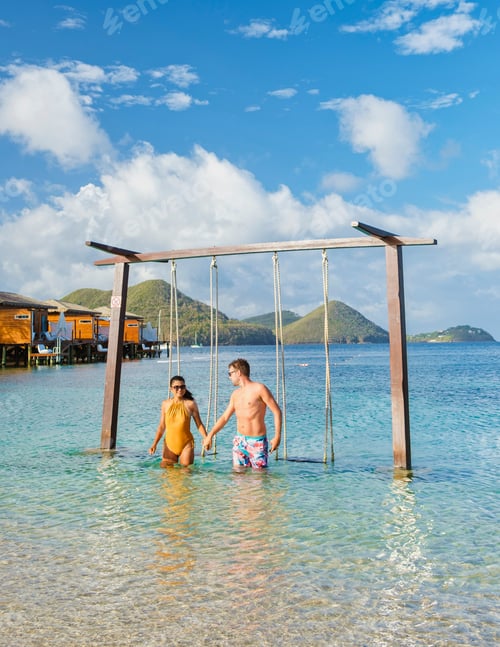 Preview: Couple in a swing on the beach of the tropical Island Saint Lucia or St Lucia Caribbean