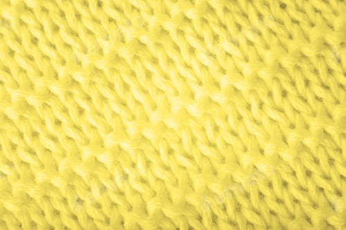 Preview: Close up of yellow knitted textured background.