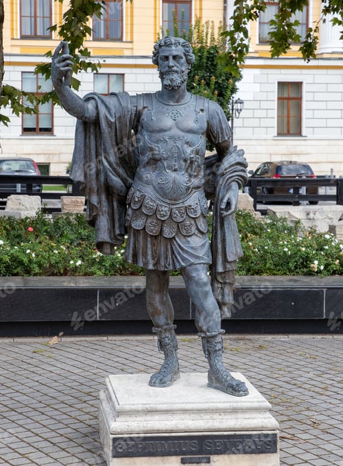 Preview: Septimius Severus Statue in a public square with buildings, parked cars and plants in the background